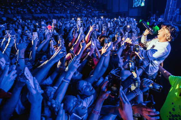 Member of Latin Mafia band performs with the crowd during a concert at Auditorio Citibanamex on September 10, 2023 in Monterrey, Mexico.