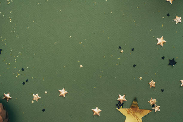 merry christmas! stylish christmas border with festive decorations, confetti, fir branches on green background. christmas flat lay, seasons greetings card template, space for text - garden decoration stock pictures, royalty-f