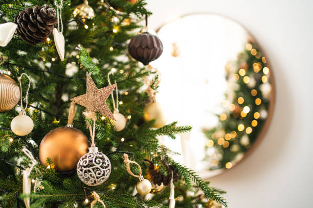 merry christmas tree with many different decorations and festive lights near mirror. new year celebration concept. beautiful backdrop for your design - home decoration stock pictures, royalty-free photos & images