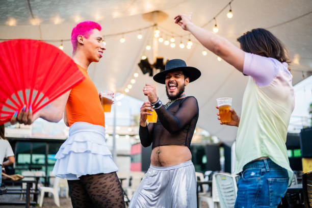 mid adult friends dancing on a gay festival - concert stock pictures, royalty-free photos & images