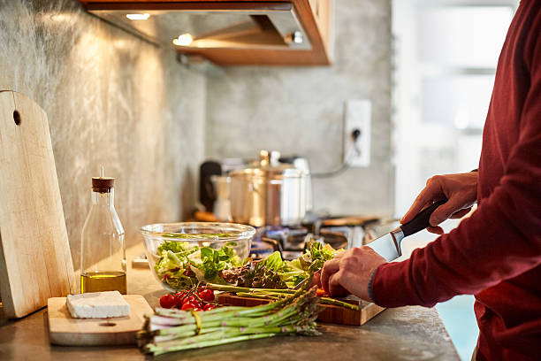 midsection of man cutting vegetables - food stock pictures, royalty-free photos & images