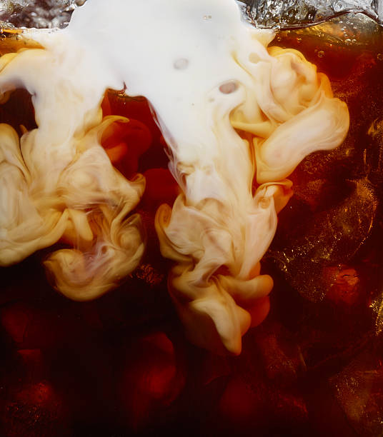 milk pour into iced coffee - coffee stock pictures, royalty-free photos & images