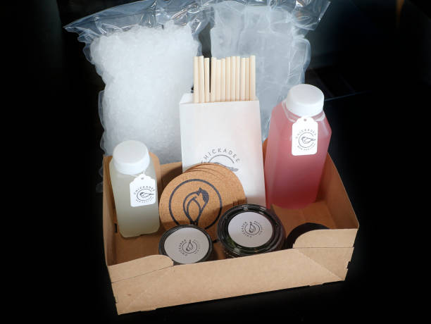 Mixed drinks to go, including a margarita, left, and a cosmopolitan with crushed ice, ice cubes, straws, salt, limes and coasters served at Chickadee...