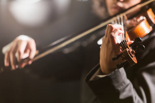mixed race teenage boy playing the violin - concert stock pictures, royalty-free photos & images