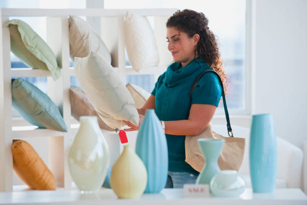 mixed race woman shopping for pillows - home decoration stock pictures, royalty-free photos & images