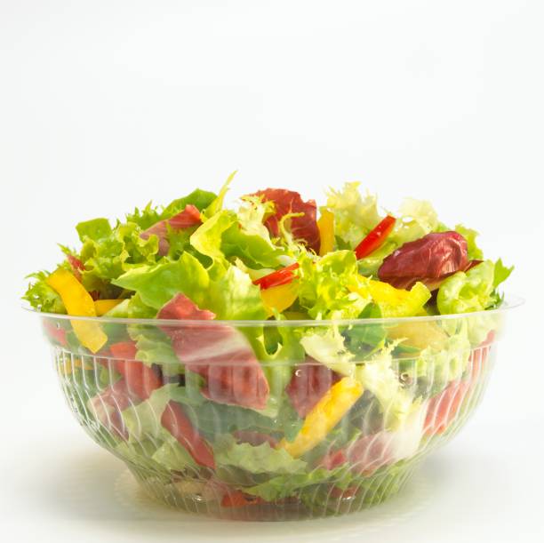 mixed salad in plastic bowl, close-up - junk food stock pictures, royalty-free photos & images