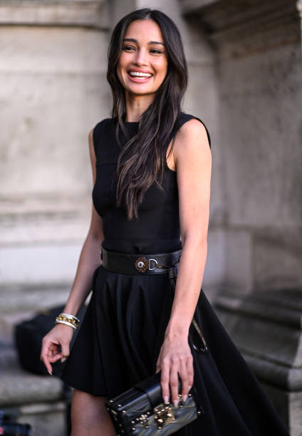 Model Kelsey Merritt is seen wearing a black Louis Vuitton dress, black belt and Louis Vuitton handbag outside the Louis Vuitton show during...