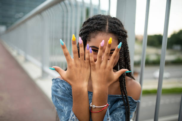 model on city bridge posing with colorful nails - fashion stock pictures, royalty-free photos & images