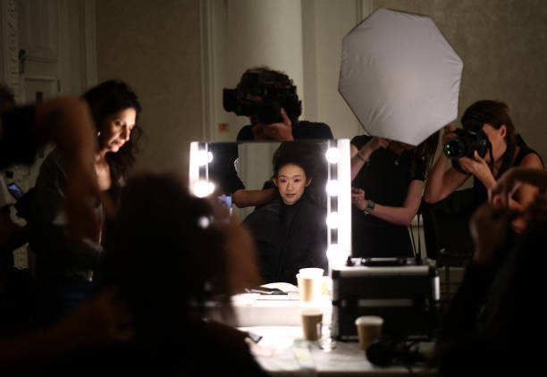 Models have their hair and make up prepared backstage, ahead of presenting creation for the Paul Costelloe Spring/Summer 2025 collection, at London...