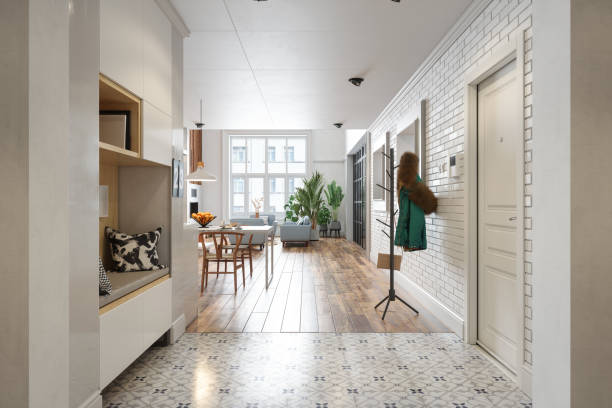 modern hallway with coat hanger, living room, dining table and houseplants - home decoration stock pictures, royalty-free photos & images