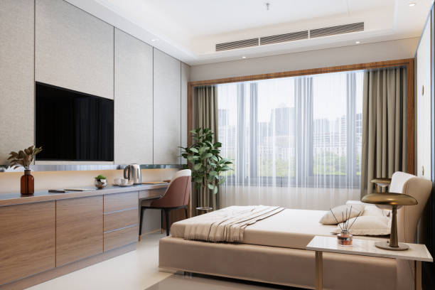 modern hotel room with double bed, night tables, tv set and cityscape from the window - home decoration stock pictures, royalty-free photos & images