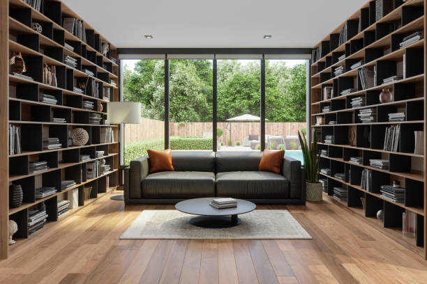 modern living room interior with leather sofa, bookshelf, floor lamp and garden view through the window - garden decoration stock pictures, royalty-free photos & images