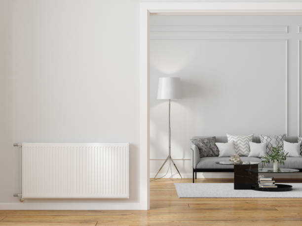 modern living room interior with radiator on blank wall, sofa, coffee table and floor lamp - home decoration stock pictures, royalty-free photos & images