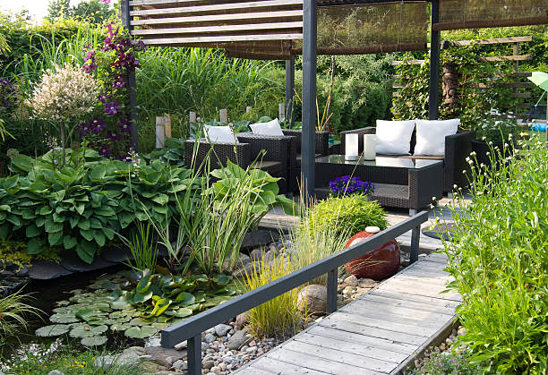 modern patio garden lounge with a pond and outdoor sofas - home decoration stock pictures, royalty-free photos & images