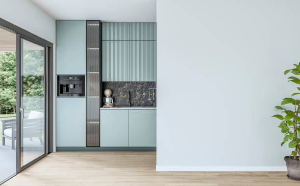 modern powder blue kitchen with large windows (garden view) in the background and a potted plant (ficus) in front of a white blank wall in the foreground - garden decoration stock pictures, royalty-free photos & images
