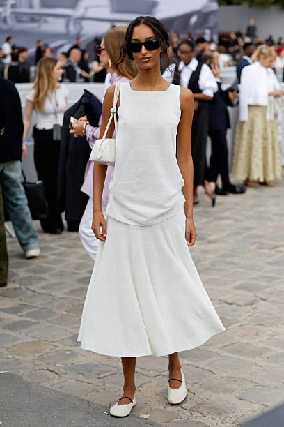 Mona Tougaard wears white top, white midi skirt, white bag, white ballet flats, outside Dior, during the Menswear Spring/Summer 2026 show as part of...