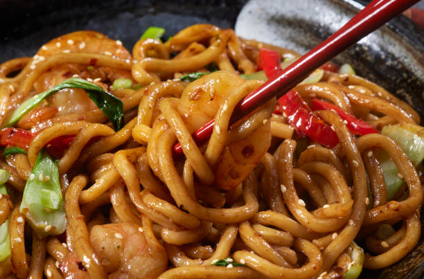 mongolian shrimp with udon noodles - junk food stock pictures, royalty-free photos & images