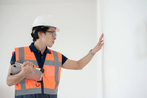 monitoring interior wall inspections within a virtual environment. male japanese construction engineer is final inspection of the surface a interior wall during the house building delivery. - home decoration stock pictures, r