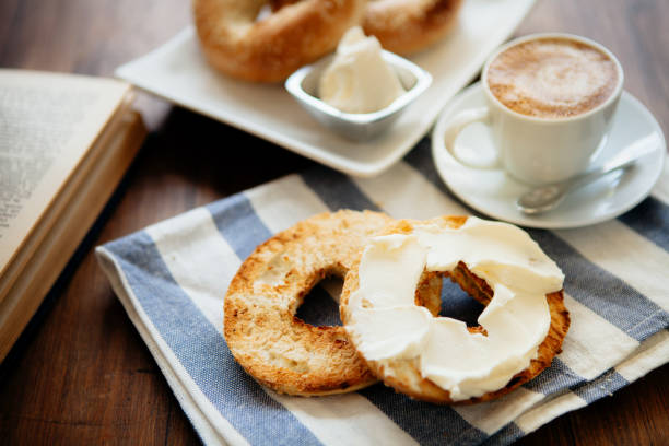 montreal style bagels on a plate with cream cheese and coffee - food stock pictures, royalty-free photos & images