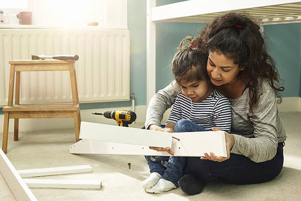 mother and daughter building furniture - home decoration stock pictures, royalty-free photos & images