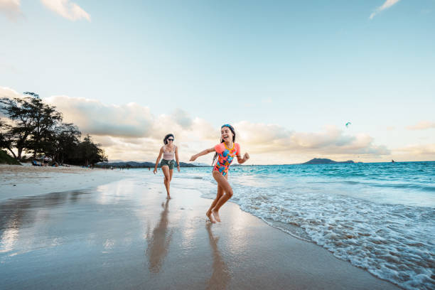 mother and daughter play on the beach - travel stock pictures, royalty-free photos & images