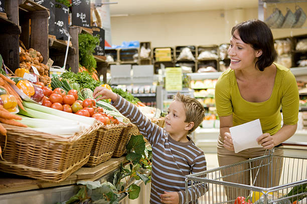 mother and son in supermarket - food stock pictures, royalty-free photos & images
