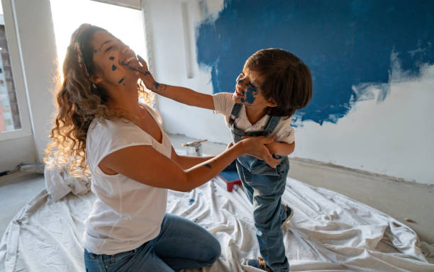 mother and son painting their house and having fun - home decoration stock pictures, royalty-free photos & images