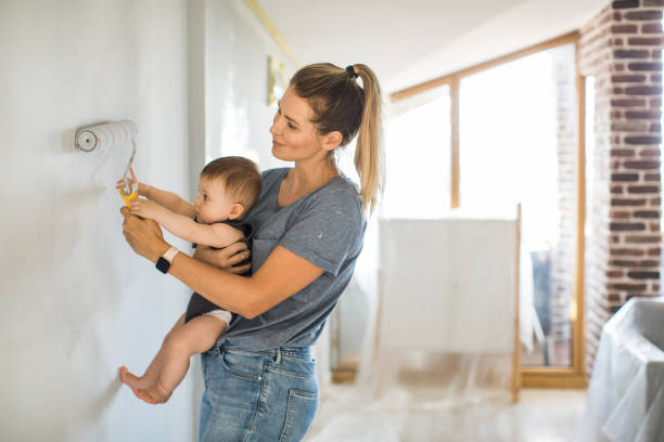 mother and son painting wall - home decoration stock pictures, royalty-free photos & images