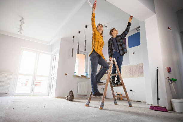 mother and son painting wall at home - home decoration stock pictures, royalty-free photos & images