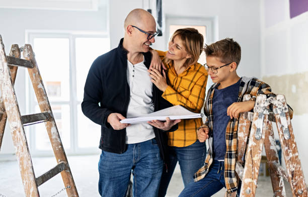 mother, father and son are talking about the changes during the home renovation - home decoration stock pictures, royalty-free photos & images