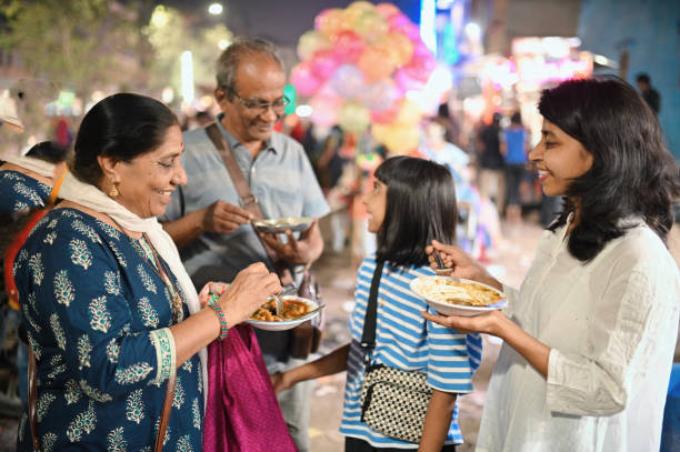 multi-generation family tourists enjoying street food - junk food stock pictures, royalty-free photos & images