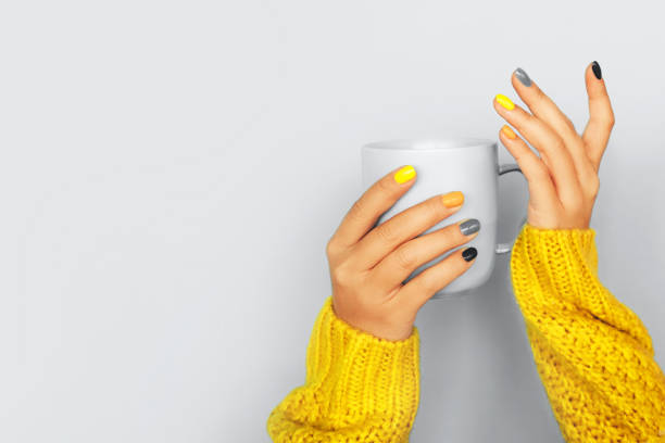 multicolored manicure with yellow and gray nails on light background. trendy colors of the year. - nails art stock pictures, royalty-free photos & images