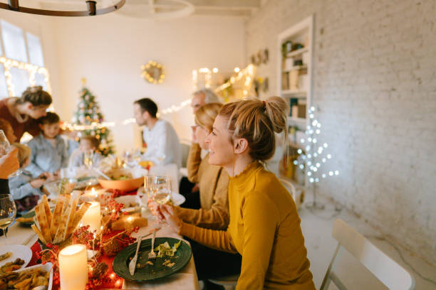 multigenerational family celebrating december holidays - food stock pictures, royalty-free photos & images