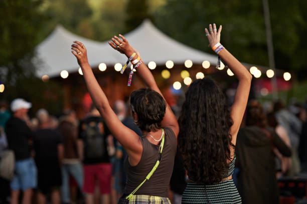 multiracial female friends dancing with arms raised - concert stock pictures, royalty-free photos & images