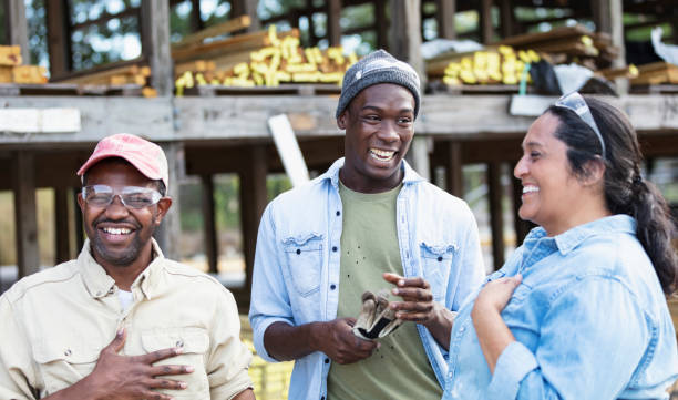 multiracial group of workers at lumberyard, laughing - home decoration stockfoto's en -beelden