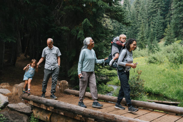 multiracial multigenerational family on a hike - travel stock pictures, royalty-free photos & images
