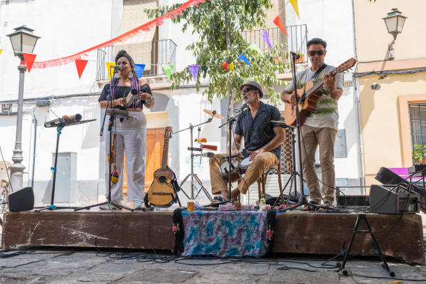 music band performing at an outdoor stage on the street. - concert stock pictures, royalty-free photos & images