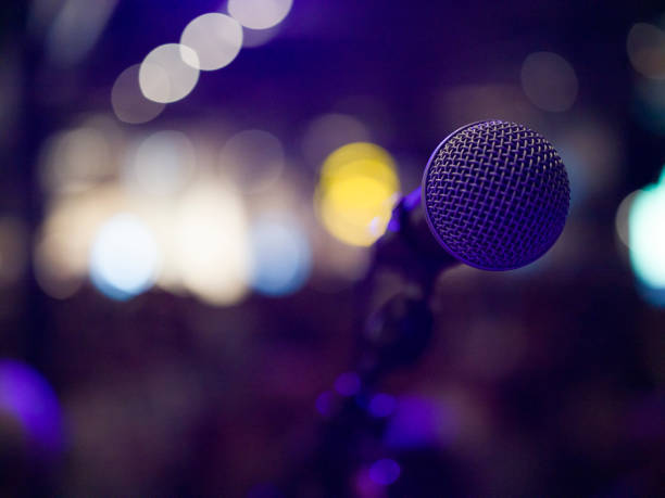 musical microphone on a concert stage - concert stock pictures, royalty-free photos & images