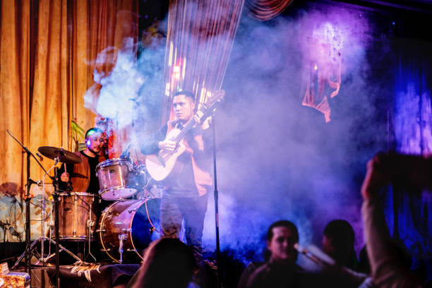 musician man playing guitar in a music concert - concert stock pictures, royalty-free photos & images