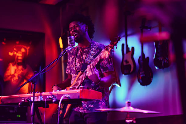 musician performing on stage with guitar - concert stock pictures, royalty-free photos & images