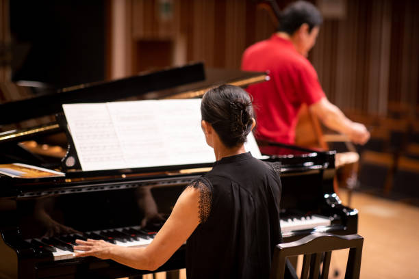 musician playing cello and piano at classical concert - concert stock pictures, royalty-free photos & images