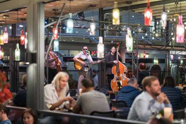 musicians playing in an outdoor cafe. - concert stock pictures, royalty-free photos & images