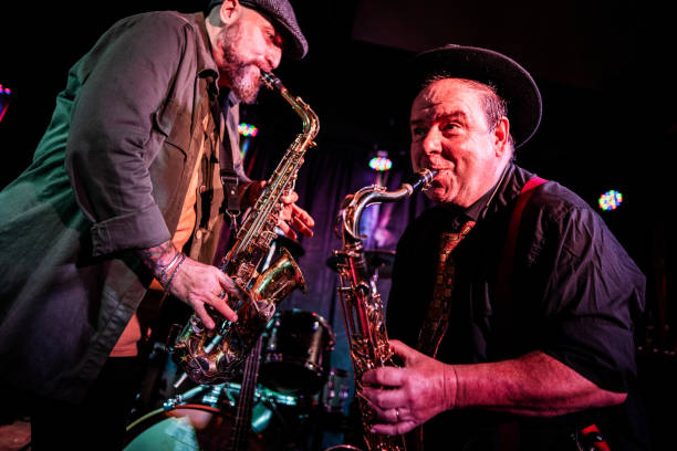 musicians playing saxophone at nightclub - concert stock pictures, royalty-free photos & images