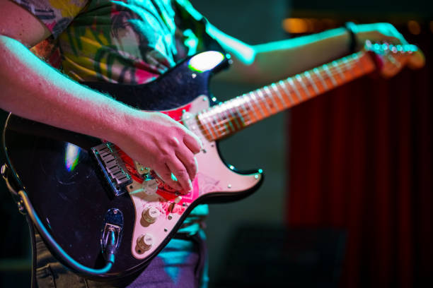 musicians tuning the guitar on stage - concert stock pictures, royalty-free photos & images