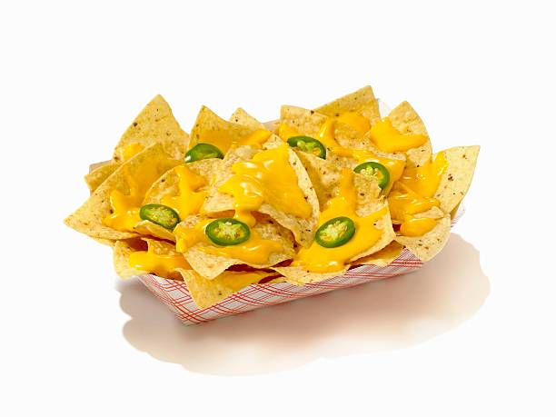 nachos with cheese sauce and sliced jalapenos in a take out container - junk food stock pictures, royalty-free photos & images