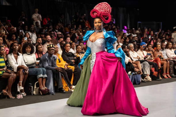 Nigerian influencer Anita Natacha Akide, popularly known as Symply Tacha, wears a creation by Nigerian hair brand Lush Hair as she walks the runway...