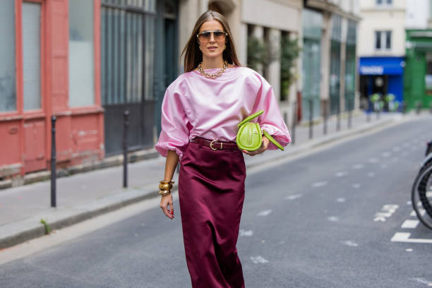Nina Sandbech wears burgundy skirt and pink top homemade, green bag Mietis, sunglasses Loewe during Womenswear Spring/Summer 2025 as part of Paris...
