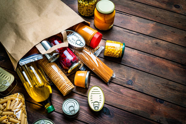 non-perishable foods coming out a paper bag. copy space - food stock pictures, royalty-free photos & images