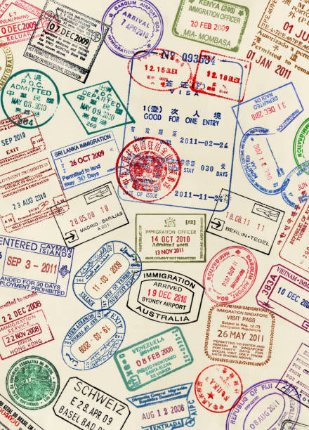 numerous visa stamps on a passport page - travel stock pictures, royalty-free photos & images