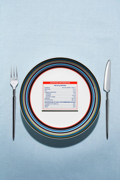 nutrition label on plate in table setting - junk food stock pictures, royalty-free photos & images